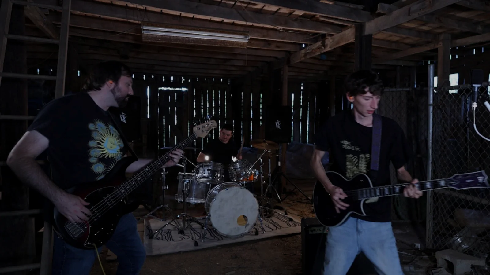 Idle Index performing in a dark wooden barn