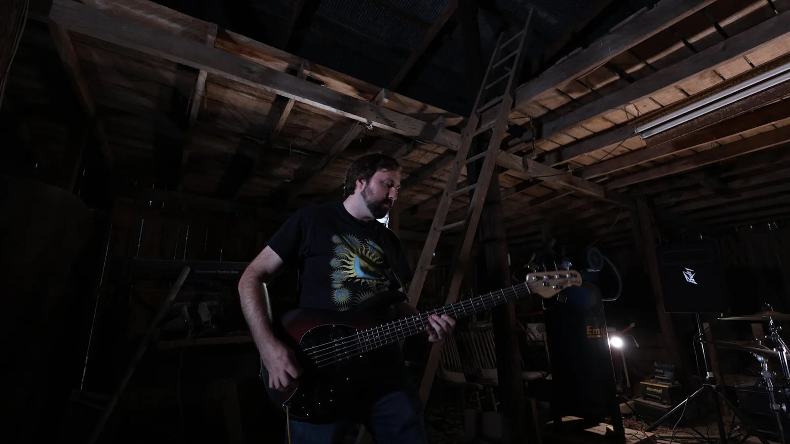 Idle Index bassist performing in a wooden barn